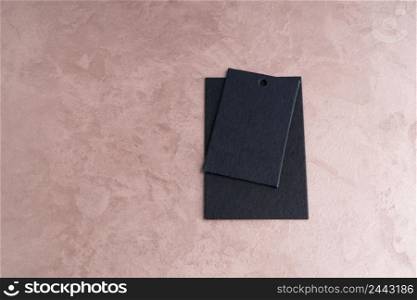 two black price tags isolated on decorative textured background. the label on ornamental background