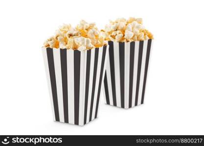 Two black white striped carton buckets with tasty cheese popcorn, isolated on white background. Movies, cinema and entertainment concept.