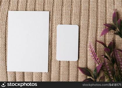 two blank card and a leaf on a sweater