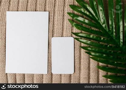 two blank card and a leaf on a sweater