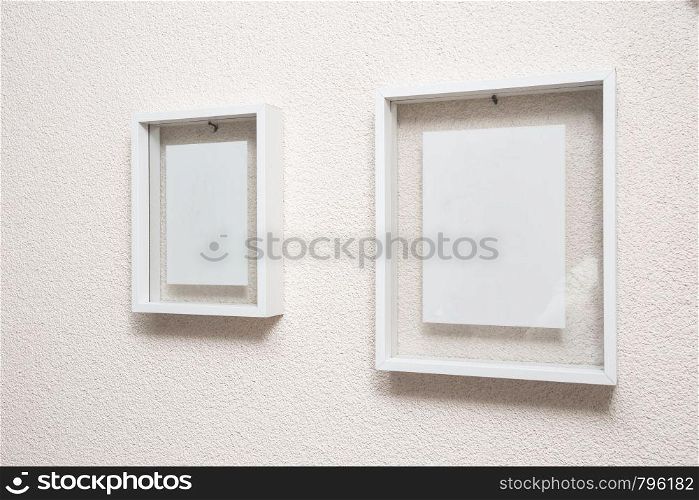 Two blank frame on white wall clean modern design texture. Two blank frame on white wall clean modern design