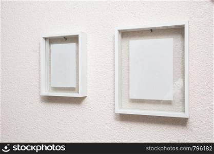 Two blank frame on white wall clean modern design texture. Two blank frame on white wall clean modern design