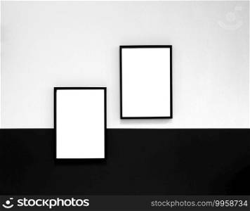 Two blank Poster,canvas,frame hanging on black and white wall, interior design modern mock up frames copy space, space for text. Two blank Poster,canvas,frame hanging on black and white wall, interior design modern mock up frames copy space,