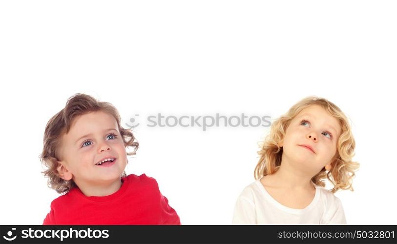 Two blond children looking up isolated on a white backround