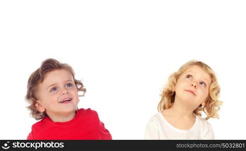 Two blond children looking up isolated on a white backround
