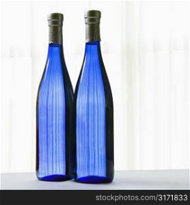 Two blue bottles with on white.