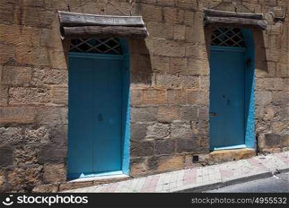 Two blue doors on a street in Gozo, Malta
