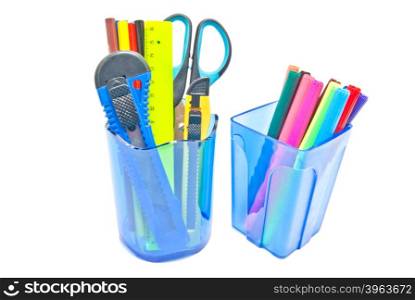 two blue glasses with office supplies on white