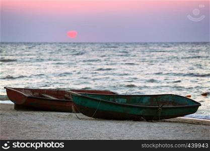 Two boats on the seashore at dawn