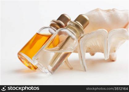 two bottle of medicine and sea shells