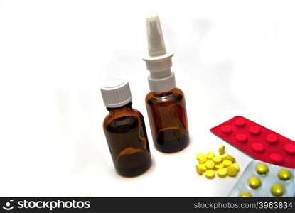 Two bottles and pills on white background