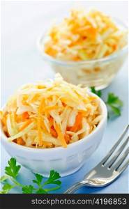 Two bowls of fresh coleslaw with shredded cabbage