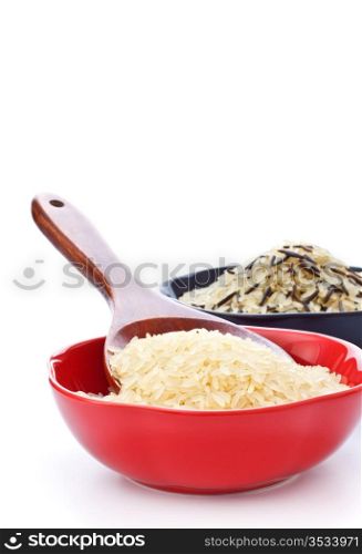 two bowls with rice and wooden spoon