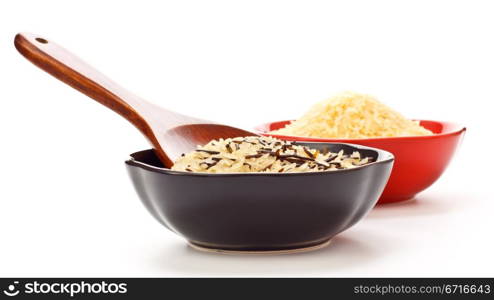 two bowls with rice and wooden spoon