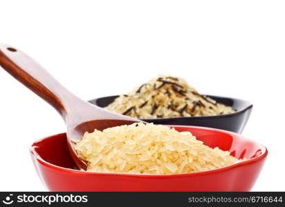 two bowls with rice and wooden spoon