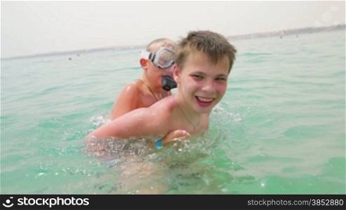 Two boys are playing and having fun in the sea
