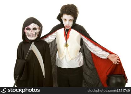 Two boys dressed for Halloween as a vampire and the grim reaper. Isolated on white.