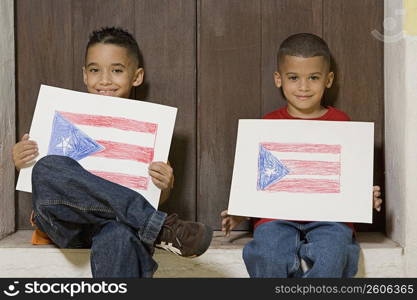 Two boys holding drawing of the Puerto Rican flag