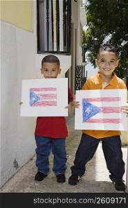 Two boys holding drawing of the Puerto Rican flag