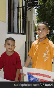 Two boys holding drawing of the Puerto Rican flag