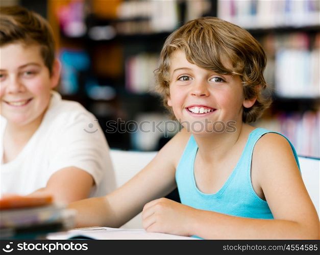 Two boys in library with books. Two boys in library