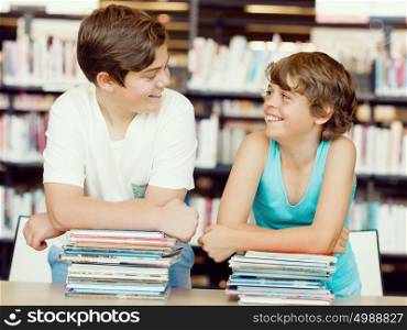 Two boys in library with books. Two boys in library
