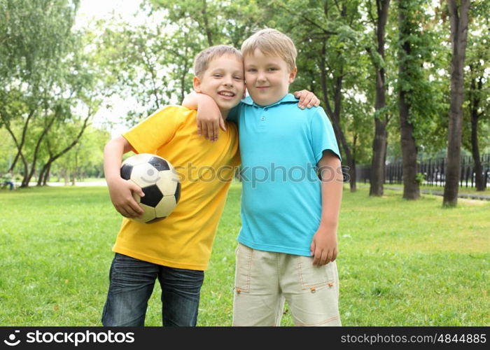 two boys in the park with a ball