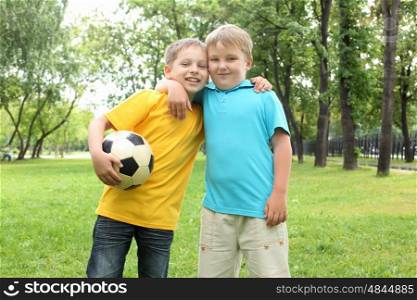 two boys in the park with a ball