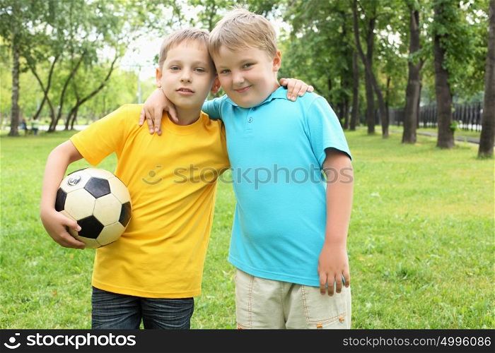 two boys in the park with a ball