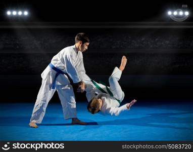 Two boys martial arts fighters at sports hall
