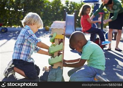 Two Boys Playing With Toy In Playground