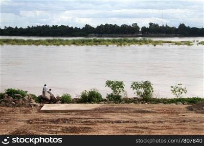 Two boys seting on the bank of Mekong in Vientian, Laos