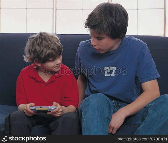 two boys sharing a video game