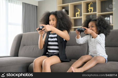 Two brothers of an Asian-African American family. Relax and play online games in the living room of the house.