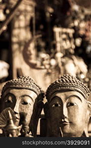 Two buddha heads in sepia. Two sepia buddha heads made of stone bagan myanmar