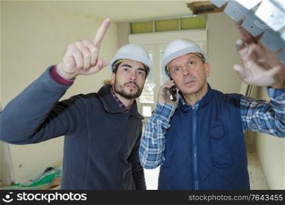 two builders in uniform having discussion