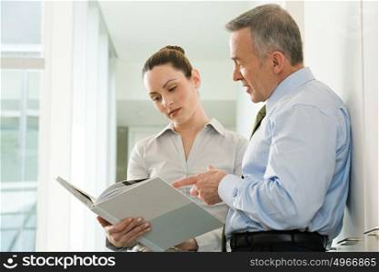 Two business colleagues reading a document