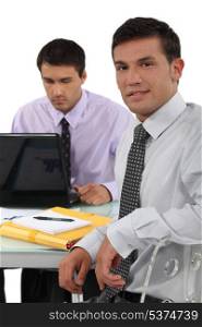 Two business colleagues sat at desk
