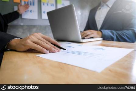 two business executives analyzing data paper at meeting room