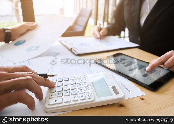 Two business executives discussing data documents of stock market in modern office