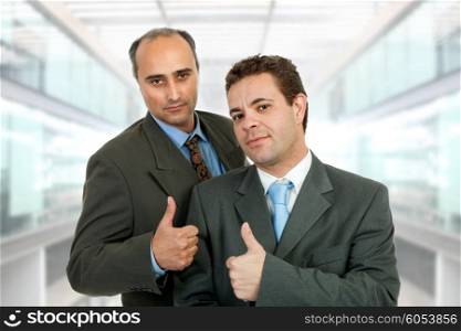 two business men going thumb up, at the office