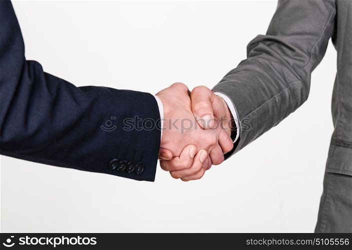 Two business men handshaking. Two businessmen handshaking on gray background