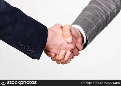Two business men handshaking. Two businessmen handshaking on gray background