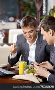 Two business men have dinner at restaurant