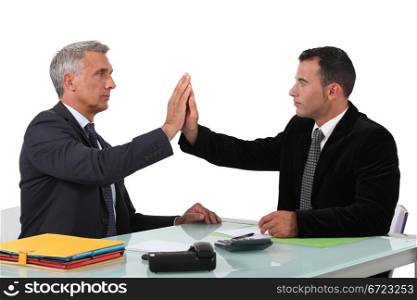 Two business men high-five