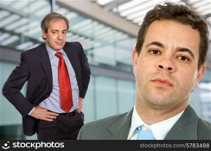 two business men portrait in a office building