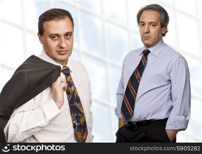 two business men portrait standing in front of a modern building