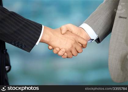 Two business men shake each other hands at office