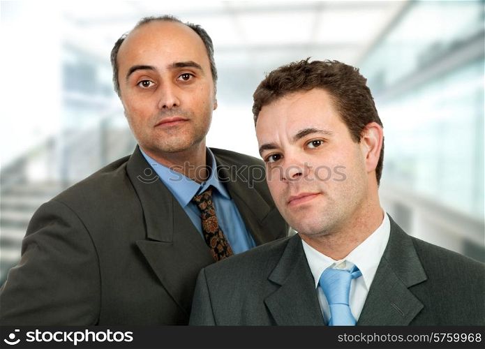 two business men standing at the office