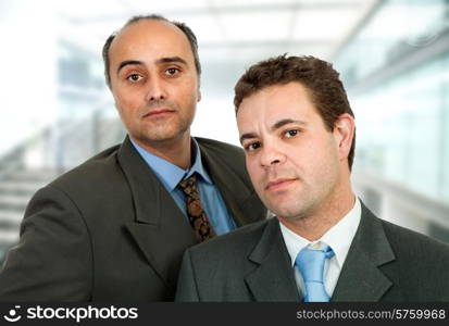 two business men standing at the office